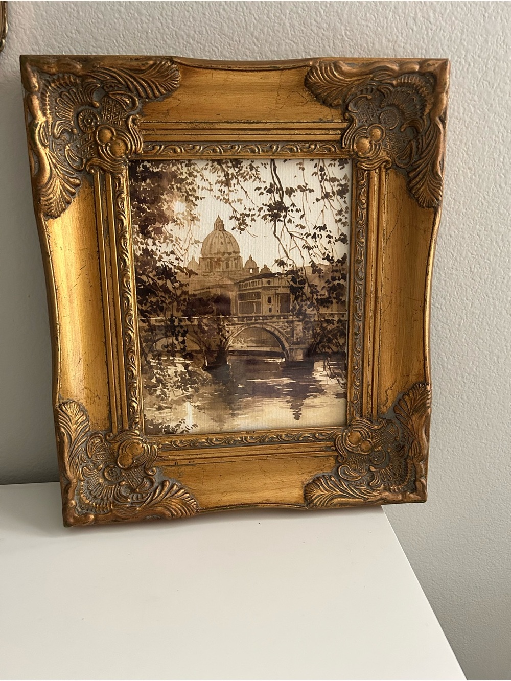 Framed art in gilded ornate frame